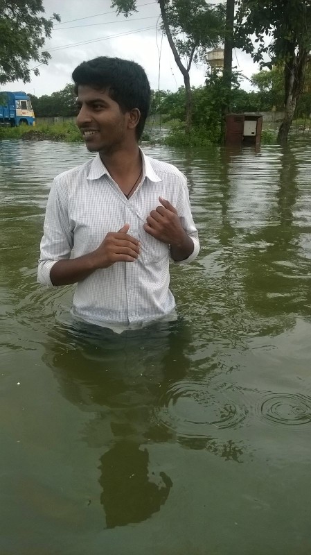 Our-associate-wading-through-water-near-the-office-449x800 Our-associate-wading-through-water-near-the-office-449x800